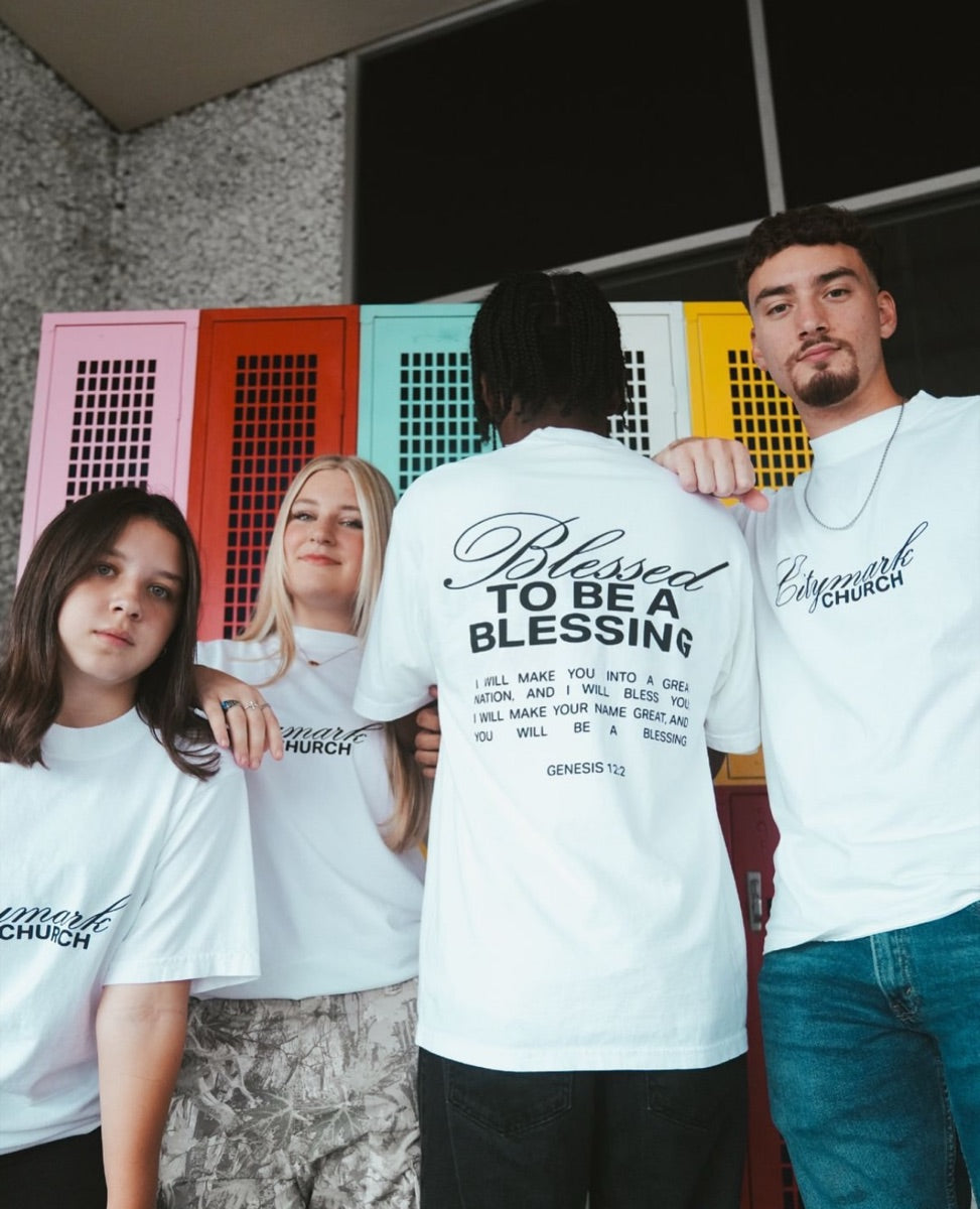 Four students in white Citymark Church tees