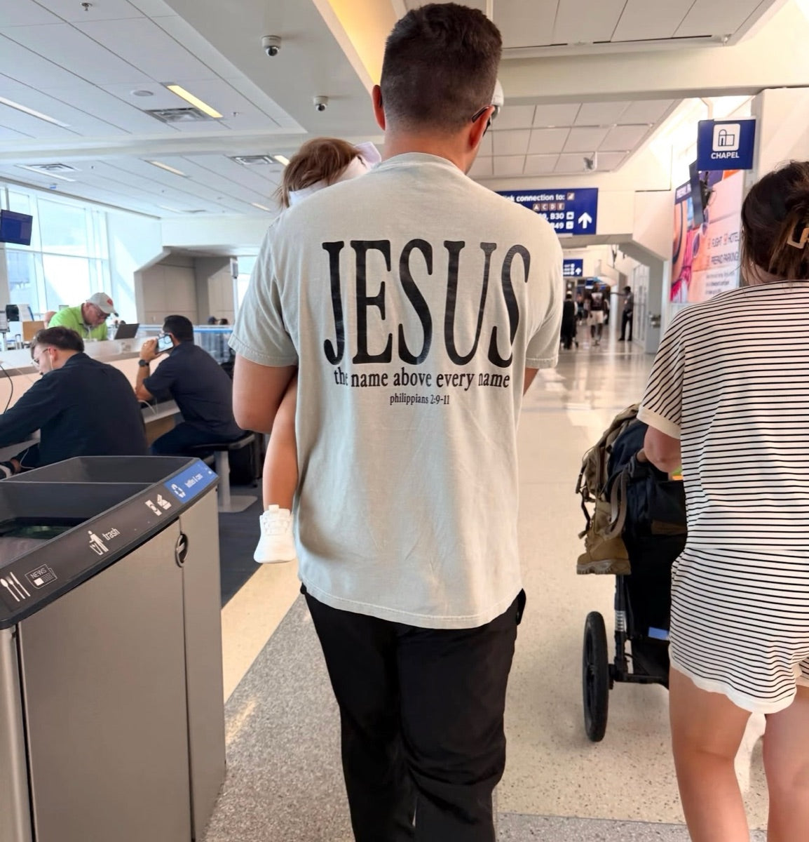 Sage Jesus tee in an airport terminal