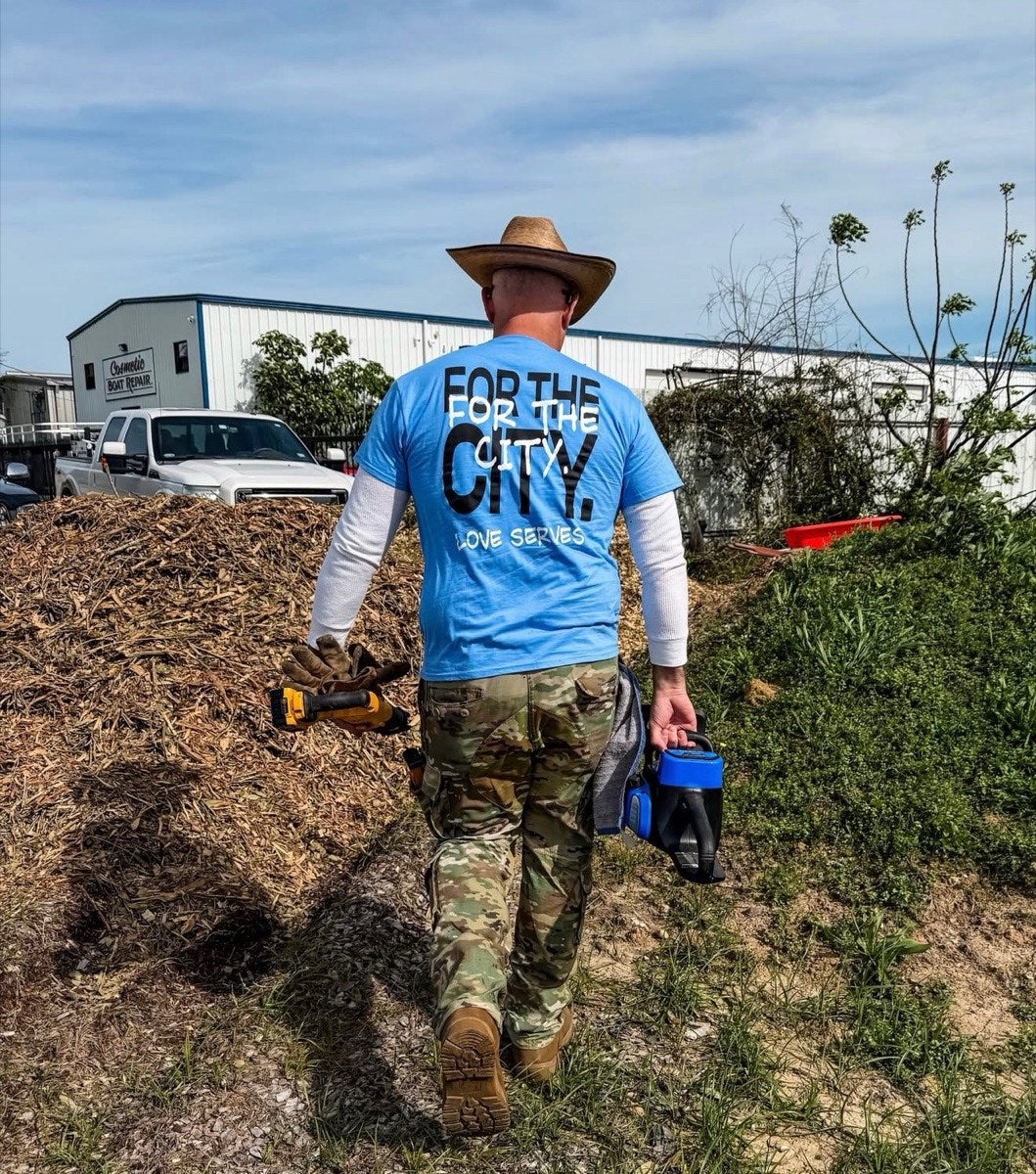 Blue For The City tee on a serve day